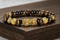 Tiger's Eye Pixiu wealth bracelet on wooden display